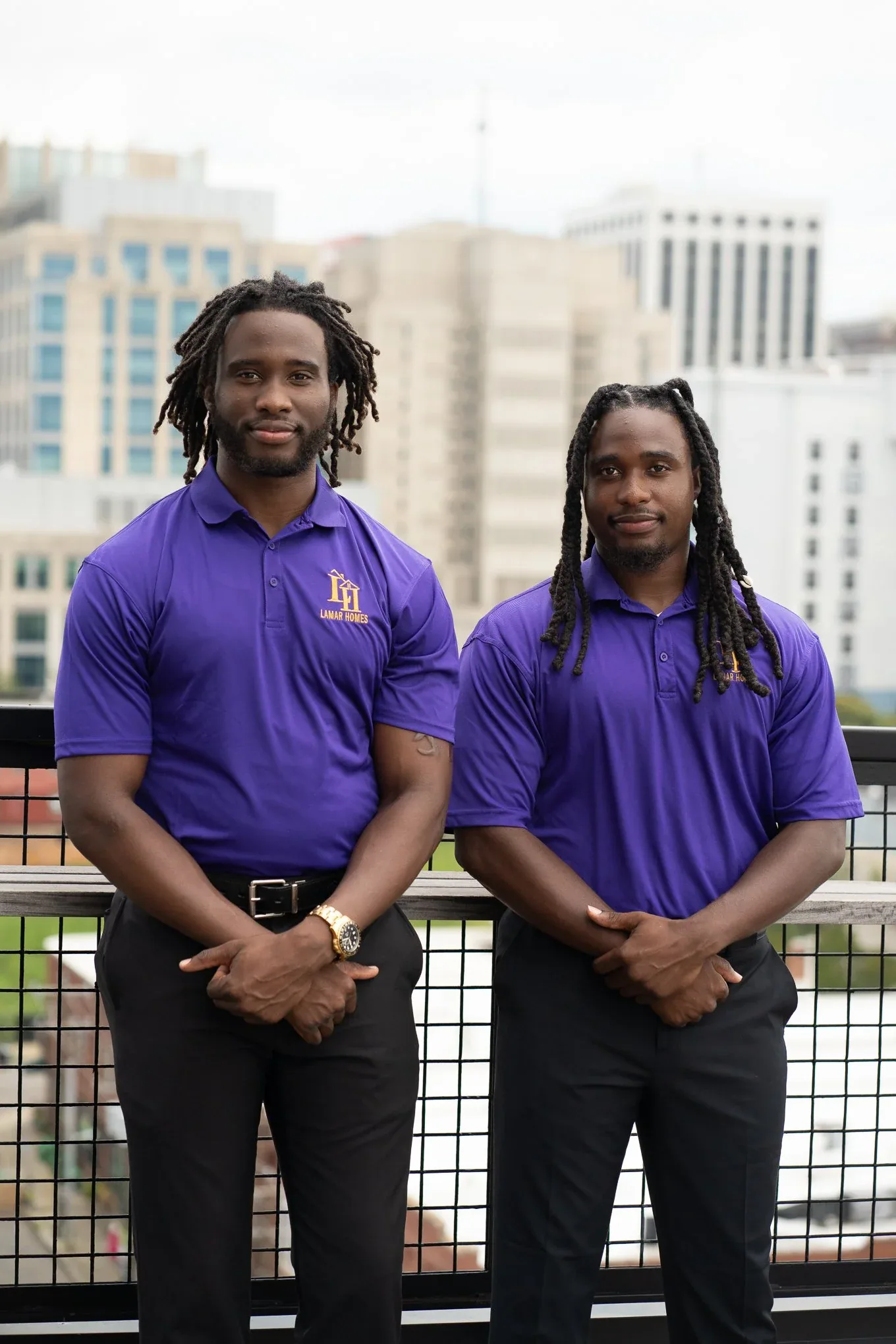 David and James Lamartiniere of Lamar Homes Roofing on a rooftop terrace in downtown Raleigh