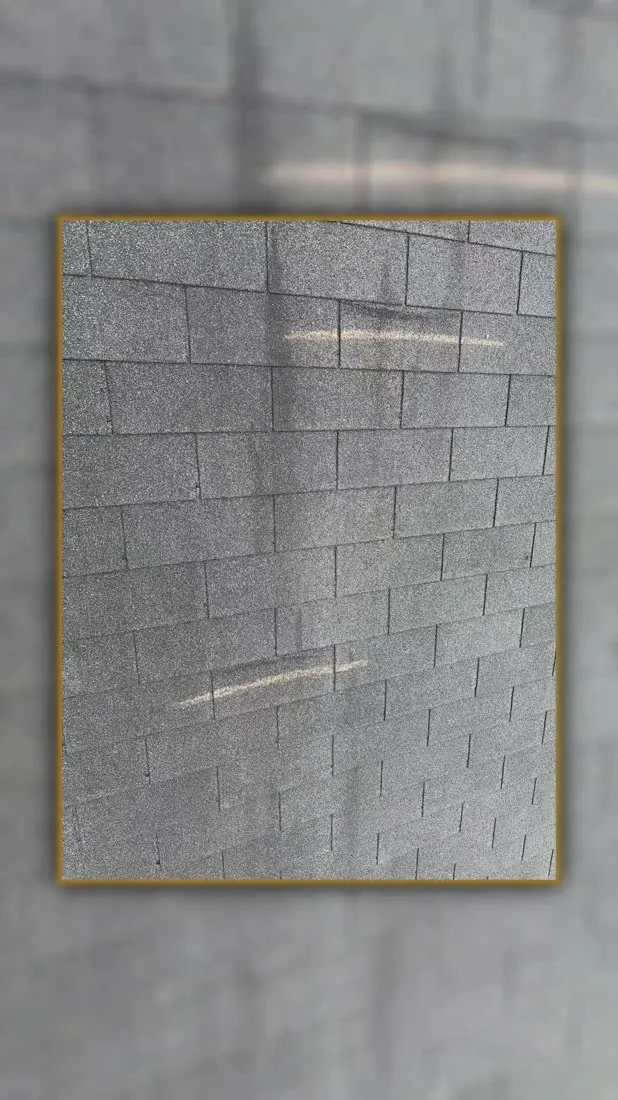 Impact bruising on the shingle surface, marked up during the inspection